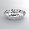 Silver wavy bowl on a light gray background