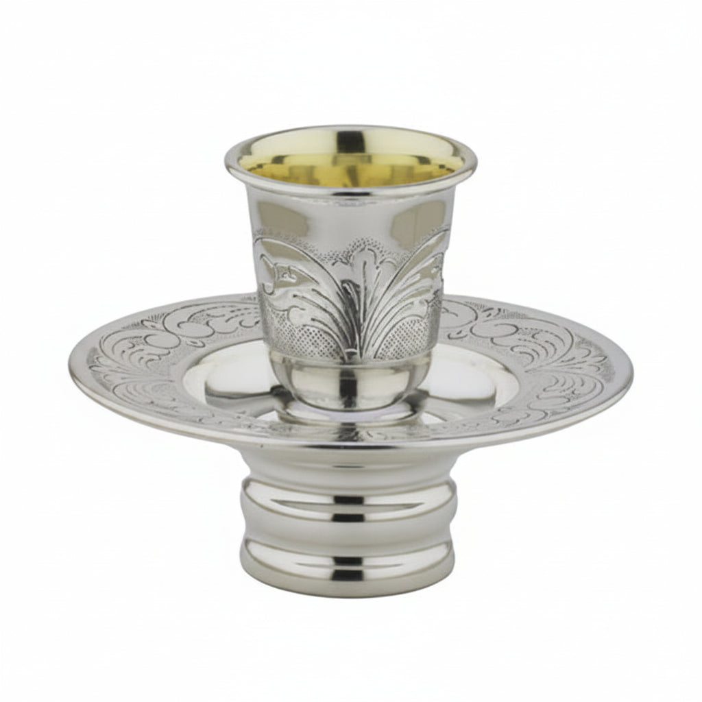 Silver kiddush cup mayim achronim with ornate design on a white background