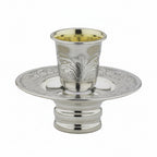 Silver kiddush cup mayim achronim with ornate design on a white background
