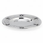 Silver kiddush cup with gold interior on a matching tray against a white background