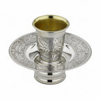 Silver kiddush cup mayim achronim with ornate design on a white background