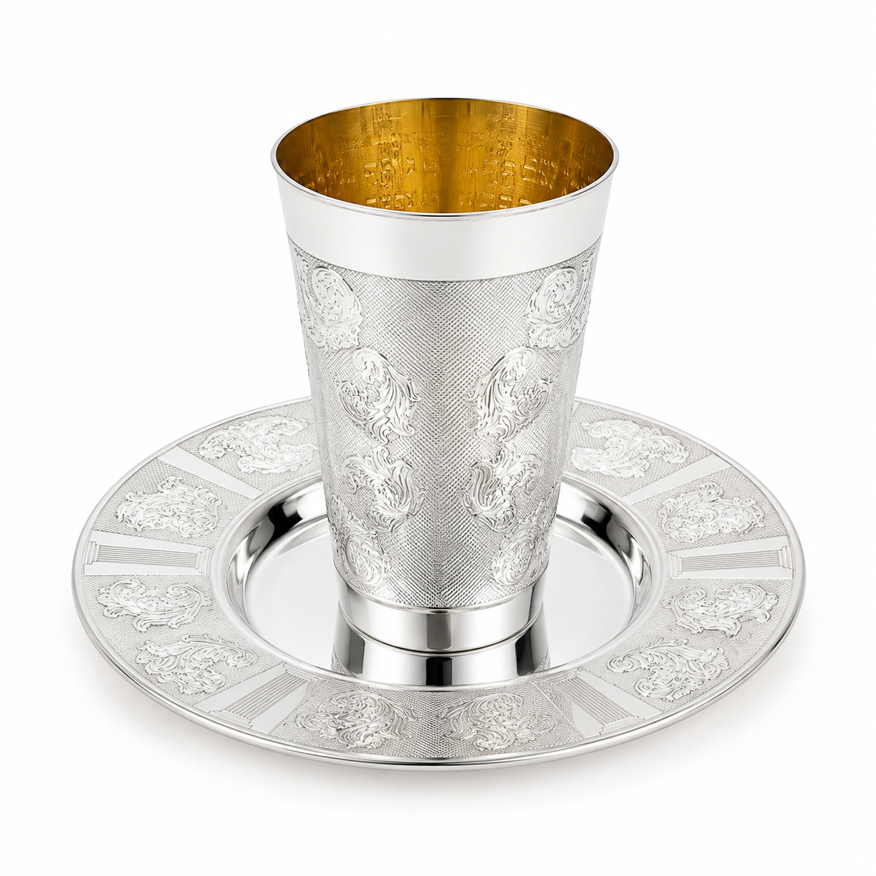 A silver Kiddush cup with an ornate floral engraving pattern, shown on a matching silver Kiddush plate by hadad bros silverware