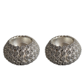 Two silver textured candle holders on a white background