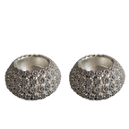 Two silver textured candle holders on a white background