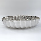 Silver decorative plate with wavy edge on a white background