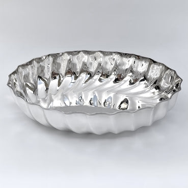 Silver decorative plate with wavy edge on a white background