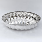 Silver decorative plate with wavy edge on a white background