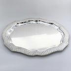 Silver decorative tray on a light gray background