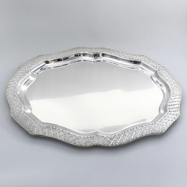 Silver decorative tray on a light gray background