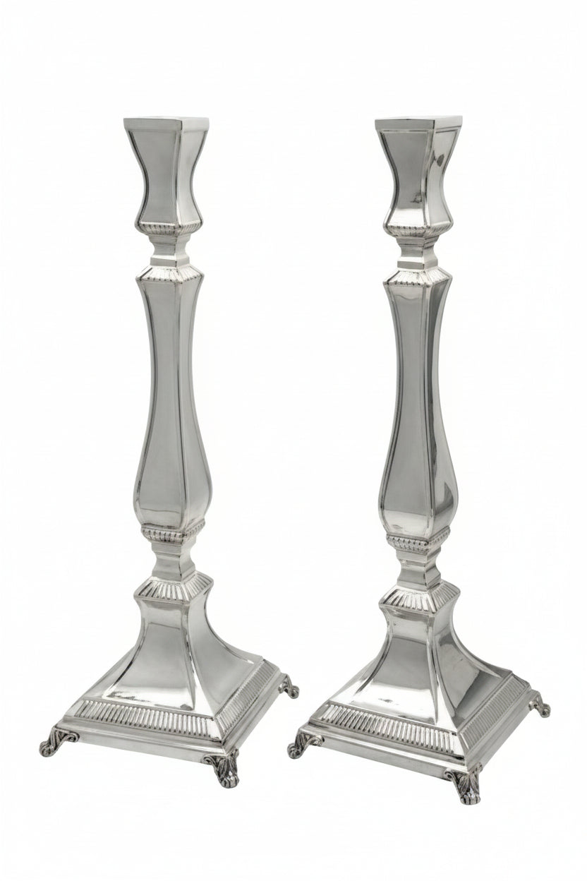 Two silver candle holders on a white background