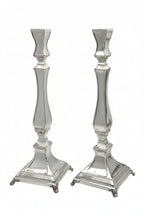 Two silver candle holders on a white background