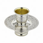 Silver kiddush cup mayim achronim with ornate design on a white background