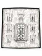 A crystal glass decanter with a stopper and six matching shot glasses,by hadad bros silverware.