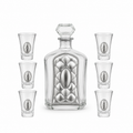 A crystal glass decanter with a stopper and six matching shot glasses,by hadad bros silverware.