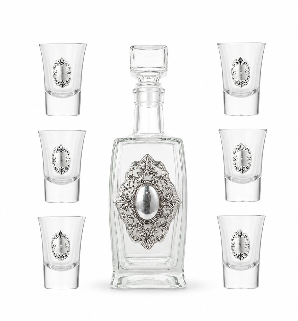 A crystal glass decanter with6 matching shot glasses by hadad bros silverware.