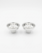 Two small polished metal cup-like holders with flared rims, shown side by side by hadad bros silverware