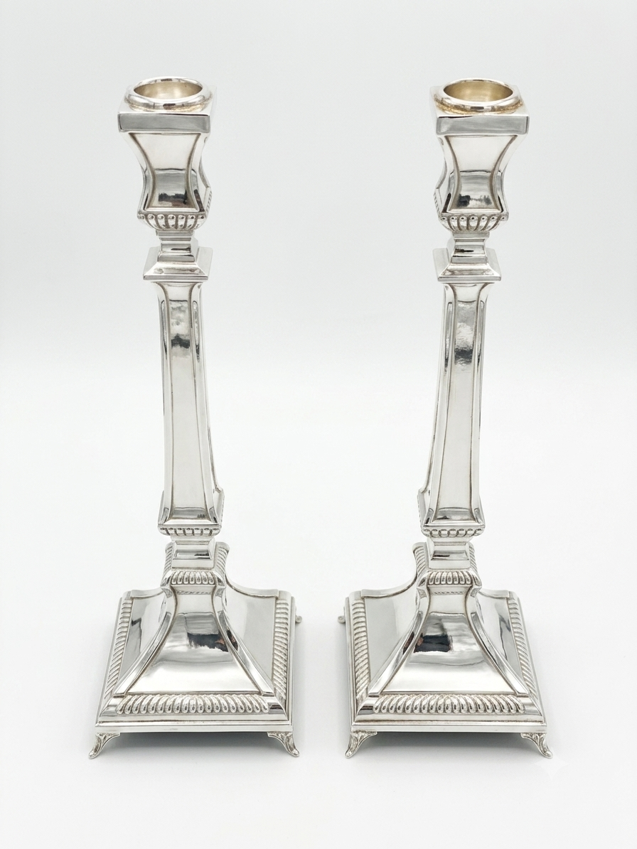 Two silver 925 candlesticks on a white background