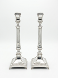 Two silver 925 candlesticks on a white background