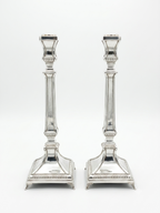 Two silver 925 candlesticks on a white background
