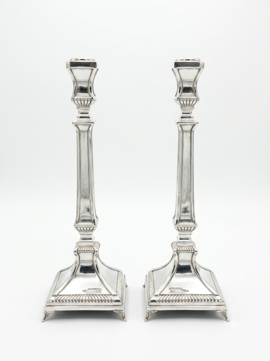 Two silver 925 candlesticks on a white background