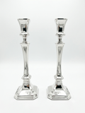 Two sterling silver 925 candlesticks on a white background
