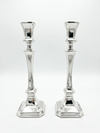 Two sterling silver 925 candlesticks on a white background