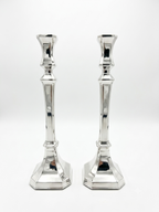 Two silver candlesticks on a white background