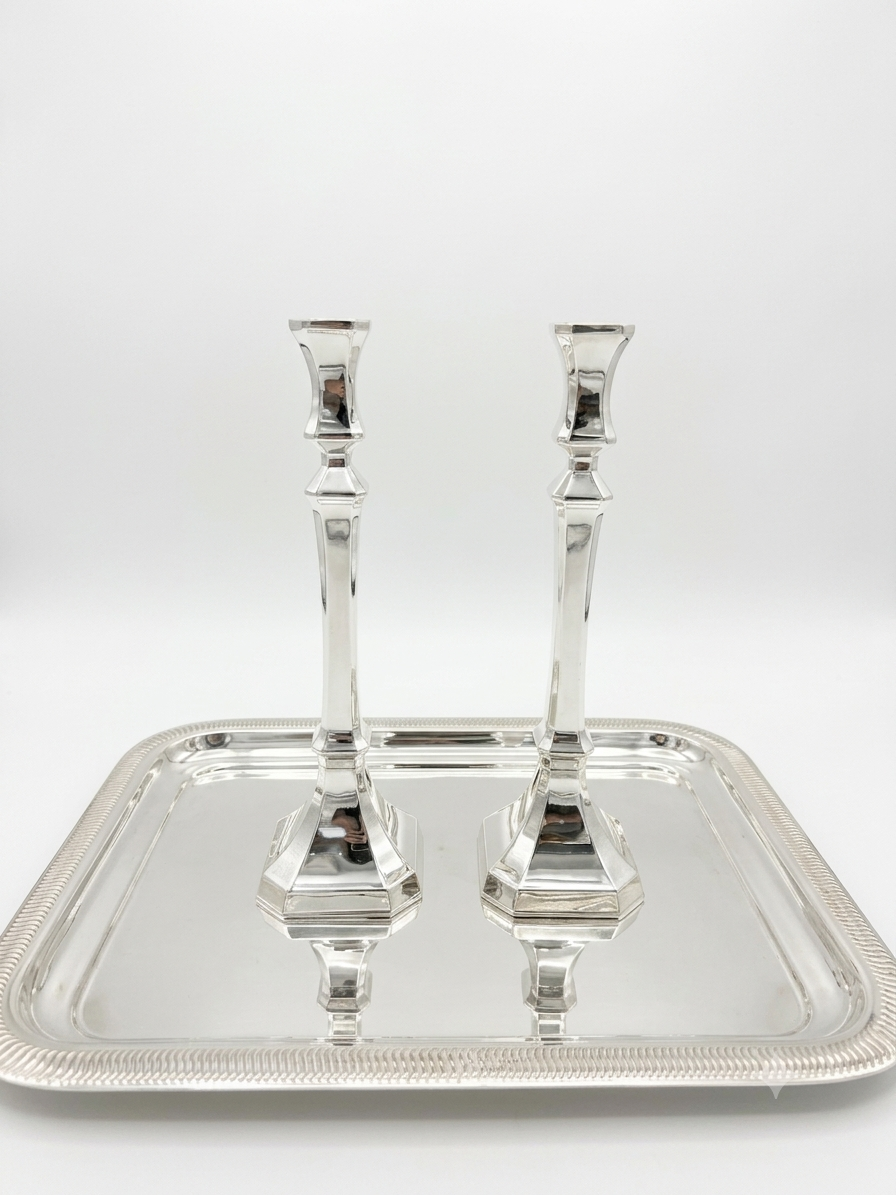 Two sterling silver 925 candlesticks on a white background
