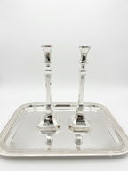 Two sterling silver 925 candlesticks on a white background