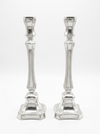 Two silver candlesticks on a white background