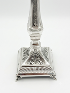Pair of silver 925 candlesticks with intricate designs on a white background