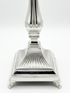 Pair of silver 925 candlesticks with intricate designs on a white background