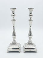 Pair of silver 925 candlesticks with intricate designs on a white background