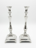 Pair of silver 925 candlesticks with intricate designs on a white background