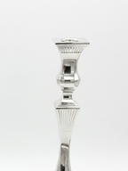 Two silver candlesticks on a white background