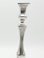 Pair of silver candlesticks with intricate designs on a white background