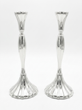 Two silver candle holders on a white background