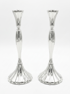 Two silver candle holders on a white background