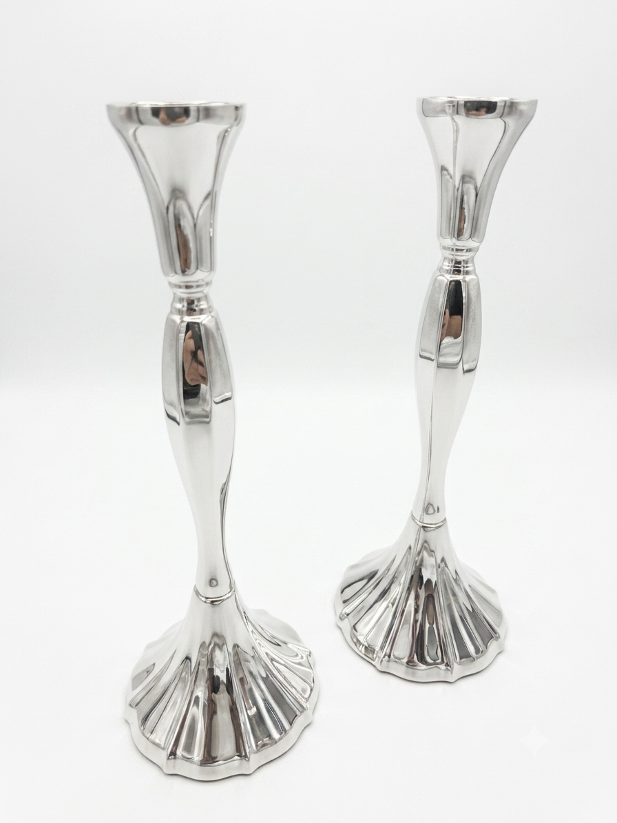 Two silver candle holders on a white background