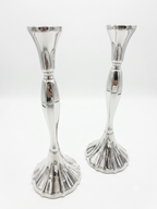 Two silver candle holders on a white background