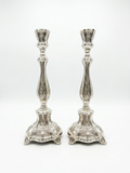 Pair of silver candlesticks on a white background