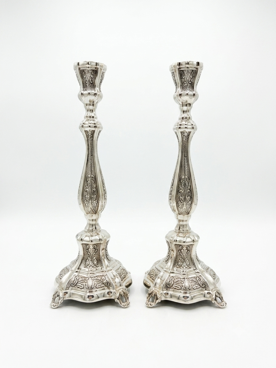 Pair of silver candlesticks on a white background