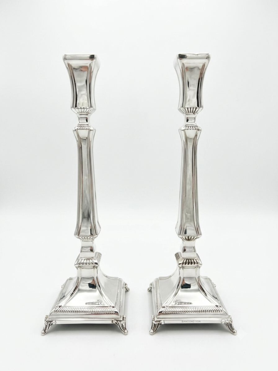 Two silver 925 candlesticks on a white background