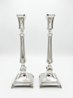 Two silver 925 candlesticks on a white background