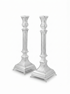 A pair of ornate silver candlesticks with detailed textured engravings and flared bases, shown against a plain white background. hammered silver candlesticks by hadad bros silverware
