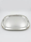 Silver tray with decorative edges on a white background