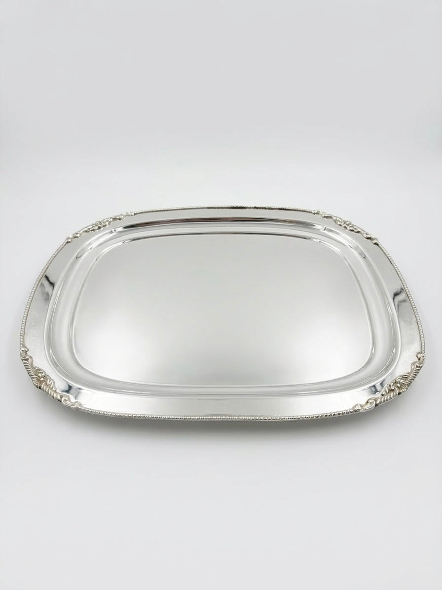 Silver tray with decorative edges on a white background