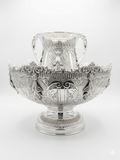 Decorative silver bowl and natla set with intricate designs on a white background