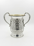 Silver natla cup with intricate designs on a white background