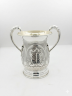 Silver natla cup with intricate designs on a white background